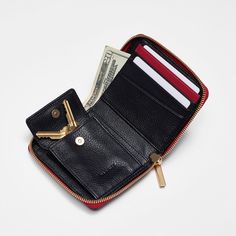 The perfect everyday wallet that fits inside all of your favorite styles featuring Hammitt's signature combo of black leather, brushed gold hardware and a red zipper pull. This compact carry-all has dedicated spaces for cards and bills, plus a secret expandable pocket that's ideal for loose keys or a chapstick. Crafted with classic black pebbled leather Brushed gold hardware, functionality covered for life Red cotton twill lining Expandable pocket with magnetic snap closure Bill pocket Four cred