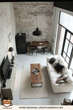 a living room filled with furniture and a flat screen tv on top of a wooden table