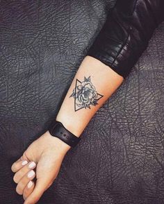 a woman's arm with a rose tattoo on it and a star in the middle