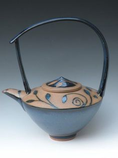 a blue and white tea pot with a handle