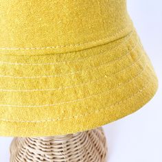 This yellow bucket hat is the perfect thing for babies toddlers and kids on sunny summer days! Washable linen and cotton fabirc makes it an easy go to for at the park, the beach, or even the backyard! This hat will protect delicate skin from the sun and will quickly become a favorite accessory! I made this sun hat from a bold yellow colored linen/cotton blend fabric. The strap closes with snaps under the chin keeps them from pulling it off. Brim measures approx. 2.25 inches. SIZES AVAILABLE 0-3