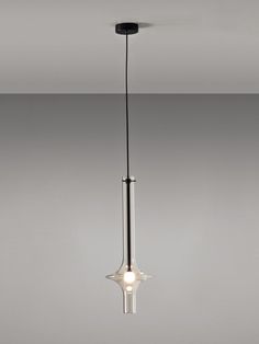 a light fixture hanging from the ceiling in a room with gray walls and flooring