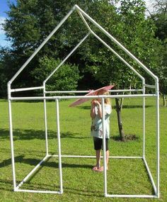 a woman standing in front of a metal structure