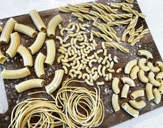 several different types of pasta on a cutting board