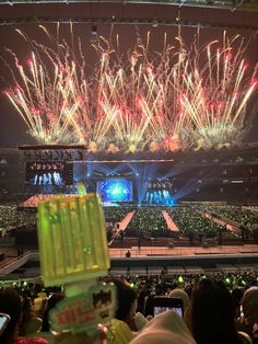 fireworks are lit up in the night sky above an arena