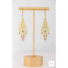 These unbelievably pretty and fashionable Amber glass filigree dangle earrings are a stunning addition to any jewelry collection. The shimmering, faceted amber glass beads are perfectly paired with the lovely gold-plated filigree and lever backs for a lightweight, secure fit and luxurious look. Beautiful, Amber and white colored faceted glass beads. Gold-plated filigree. Gold-plated wire and lever backs. 2.75 inches long. These earrings are perfect for a night out or a special event and make a m Artisan Rings, Filigree Earrings, Beaded Drop Earrings, Gemstone Jewelry Handmade, Gold Filigree, Bright Gold, Faceted Glass, Gold Drop Earrings, Rings Bracelets