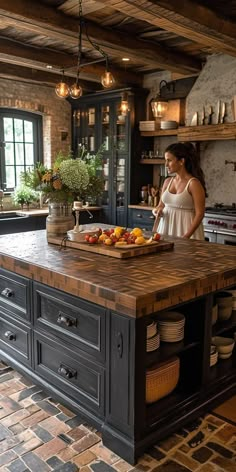 a woman standing in a kitchen next to an island with plates and bowls on it