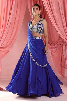 Royal blue lehenga featuring asymmetric layers and embroidered waistband. Paired with a sleeveless blouse adorned with plumeria bloom embroidery using zari, sequins, and glass beads., Fit: Relaxed Blue Plumeria, Skirt Organza, Bloom Embroidery, Lehenga With Blouse, Skirt And Blouse Set, Cancan Lehenga, Kurta Lehenga, Georgette Skirt, Blue Organza