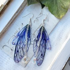 Our very pretty purple faerie wing earrings which are just perfect for any faerie! We make the wings ourselves and they are made from a type of plastic and magic, oh and a sprinkle of glitter of course! The two wings are separate which help create movement Finished with the best quality crystals and a pretty crystal drop, which catches the light perfectly! We make the wings ourselves and they are made from a type of plastic and magic, oh and a sprinkle of glitter of course! The two wings are separate which help create movement. We offer these earrings in sliver plated and bronze plated nickel free earring hooks Please note that no faeries have been harmed in the making of these wings! Villainous Outfits, Vibey Jewelry, Knight Cookie, Earrings Fairy, Tvd Dr, Wing Jewelry, Fairy Jewelry, Magical Jewelry, Pretty Purple