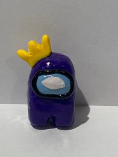 a purple toy with a yellow crown on it's head