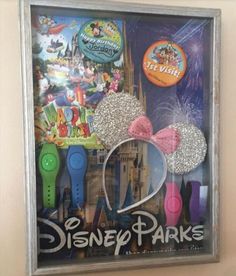 the disney parks poster is hanging on the wall