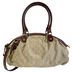 Color: Beige with brown leather Material: canvas with leather finishes Style No.: 223974 Measures: H 10” x L 18” x D 7” Drop: 8” (top handle)& 16” (shoulder strap) Comes with: shoulder strap Condition: Good. Discoloration marks to the bottom, marks and light stains throughout. Made in Italy Gucci Canvas Bags With Gold-tone Hardware, Gucci Canvas Shoulder Bag With Leather Trim, Elegant Monogram Canvas Satchel With Leather Trim, Gucci Brown Coated Canvas Shoulder Bag, Brown Gucci Coated Canvas Shoulder Bag, Gucci Canvas Bags With Leather Trim, Gucci Top Handle Shoulder Bag With Leather Trim, Gucci Shoulder Bag With Leather Trim, Gucci Shoulder Bag With Leather Trim And Double Handle