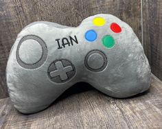 a close up of a nintendo wii controller pillow