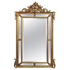 an ornate gold framed mirror on a white background