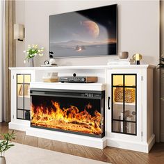 a flat screen tv mounted on a wall above a fire place in a living room