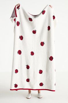 a ladybug print blanket draped over a child's dress