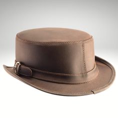 Classic Brown Hat Bands For Riding, Leather Hat With Curved Brim For Riding, Leather Riding Hat With Curved Brim, Classic Brown Hat With Leather Sweatband, Leather Curved Brim Riding Hat, Fitted Leather Hat With Short Brim, Adjustable Leather Hat Bands For Kentucky Derby, Classic Brown Top Hat With Flat Brim, Kentucky Derby Adjustable Leather Hat Bands