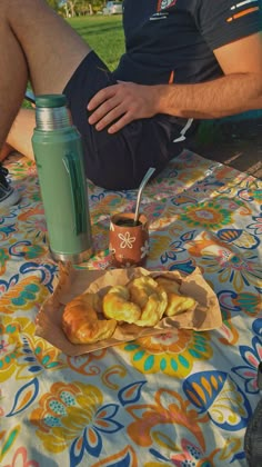 a man sitting at a table with some food and a drink in front of him