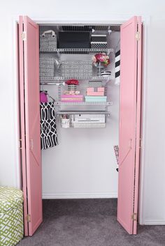 a closet with pink doors and shelves filled with books, papers and other items in it