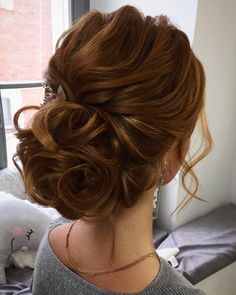 a woman with red hair is looking out the window