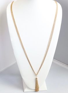 This long gold necklace is a great addition to any jewelry collection. It's a classic piece that will add a touch of elegance to any outfit. The necklace is made of high-quality gold and has a lobster claw clasp. Adjustable 16-inch Gold-tone Chain Necklace, Elegant Gold Chain Pendant Charm Necklace, Elegant Gold Chain Charm Necklace With Pendant, Elegant Metal Necklace With Large Pendant, Gold Snake Chain Necklace 16 Inch, Elegant Gold-tone Jewelry With Large Pendant, Adjustable Rose Gold Chain Necklace, Gold Dangle Necklaces For Formal Occasions, Elegant Adjustable Gold Chain Charm Necklace