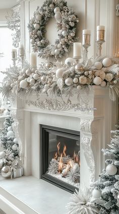 a white fireplace decorated for christmas with silver and white decorations on the mantels