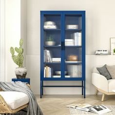 a living room filled with furniture and a blue cabinet