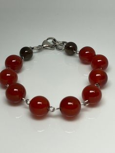 7 Inches- 10mm Red carnelian agate gemstone beads silver tone stainless steel lobster claw closure links bracelet. Hand made jewelry! All purchase will arrive in gift boxes Thanks for stopping by! Station Bracelet, Carnelian Agate, Orange Carnelian, Red Carnelian, Crystal Pendulum, Carnelian Beads, Red Agate, Large Crystals, Hanging Pendants