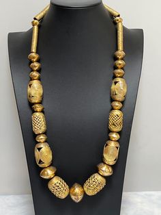 "Necklace of African handmade brass imported beads.   Bold and ethnic.  Wear it at an art opening, wedding, or just out to dinner.  Enjoy its DRAMA!  Approximately 30\"." Luxury Bohemian Beads As Statement Piece, Afrocentric Jewelry Handmade, Black African Necklace, Handmade Artisan Gold Beads, Artisan Gold Jewelry For Festivals, Unique Gold Beads For Jewelry Making, Unique Gold Necklaces With Polished Beads, Traditional Bronze Necklaces With Large Beads, Traditional Bronze Necklaces With Round Beads