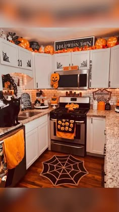 a kitchen decorated for halloween with pumpkins and decorations