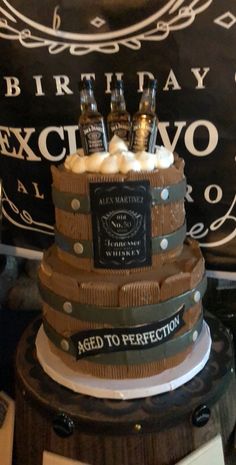 a birthday cake made to look like a barrel with bottles on top and the words aged to perfection written on it