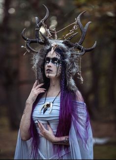 a woman with purple hair and antlers on her head