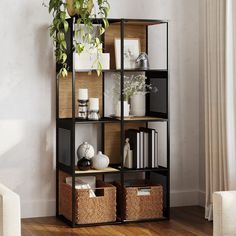 a shelf with baskets and plants on it in the corner of a living room next to a couch