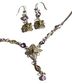 "Vintage amethyst gemstone & sterling silver lavalier necklace with earrings set. Pretty and petite purple amethyst necklace and earrings set with filligree in a flower pattern. Necklace measures 18.25\" long (extender chain included) with a 1.5\" drop length. Earrings measure 2.5\" long x 1cm wide with a .75\" drop length. The necklace & earrings are sterling silver throughout. The spring ring works perfect and is stamped 925, the earrings hooks are not stamped but are solid sterling silver also as I have been added them.  Professionally cleaned and ready to wear." Filigree Dangle Jewelry For Gifts, Filigree Dangle Earrings For Gifts, Elegant Adjustable Amethyst Necklace, Victorian Dangle Jewelry With Matching Earrings, Victorian Jewelry With Matching Dangle Earrings, Fine Jewelry With Filigree Dangle, Fine Jewelry Dangle Earrings With Filigree, Elegant Amethyst Pendant Jewelry, Silver Dangle Fine Jewelry Sets