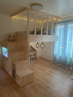 there is a loft bed in the middle of this living room with stairs leading up to it