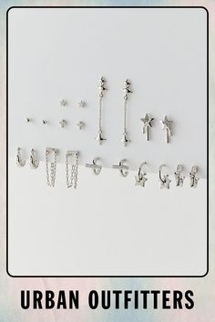 the urban outfitters logo is displayed on a white background with silver earrings and chains