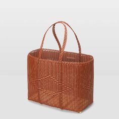 Tote bag collection  designed in italy  handmade in guatemala    the basket large is a top-handle tote that can be also carried over the shoulder. consistently with palorosa craft production this bag is entirely handwoven in guatemala incorporating recycled plastic; this material makes the product light minimalist and extremely durable. the basket large is our iconic style featuring the classic geometric tone-on-tone diamond weaving inspired by traditional guatemalan baskets. the very first basket collection initiated our research and gave birth to our brand through the unique and contemporary study of color which evokes palorosa’s unique aesthetics. the design of the bag is the expression of our master weavers’ exceptional ability – result of ancestral techniques handed down over time – a Modern Rectangular Straw Shopping Bag, Modern Rectangular Straw Bag For Shopping, Modern Brown Straw Bag With Top Carry Handle, Elegant Summer Market Bag, Modern Rectangular Bags For Market, Elegant Basket-shaped Shopping Bag, Elegant Basket Shopping Bag, Chic Bamboo Handle Bag For Market, Chic Market Bags With Bamboo Handle