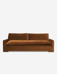 a brown couch sitting on top of a white wall