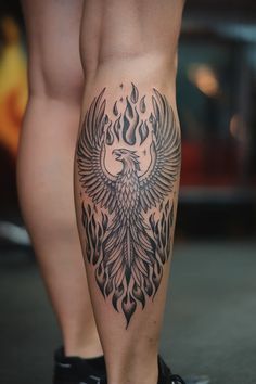 a woman's leg with a tattoo on it and a bird in the middle