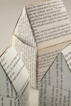 an origami house made out of book pages