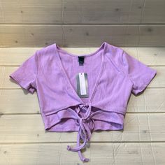 Women’s Wild Fable Short Sleeve Double Tie Versatile Light Lavender Crop Top Nwt Fitted Mauve V-neck Top, Purple Stretch Tops For Summer, Purple V-neck Top For Summer, Purple Stretch Crop Top, Lavender Fitted V-neck Tops, Spring Lavender V-neck Top, Fitted Lavender Summer Top, Fitted Lavender Top For Summer, Casual Mauve V-neck Top