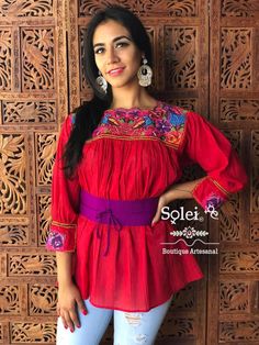 This Beautiful Mexican blouse is embroidered by Cross Stitch and has colorful florals embroidered around the collar. Please note: This blouse comes in one size which fits sizes Small, Medium and Large. You have the option of purchasing the blouse with the belt for a special price or the blouse on its own. The Jewelry modeled may be purchased separately in another post. Multicolor Long Sleeve Smocked Blouse, Multicolor Long Sleeve Smock Blouse, Multicolor Smock Blouse With Long Sleeves, Multicolor Bohemian Tunic Peasant Top, Bohemian Multicolor Peasant Tunic Top, Multicolor Bohemian Blouse For Fiesta, Bohemian Multicolor Blouse For Fiesta, Traditional Red Top With Yoke, Multicolor Long Sleeve Bohemian Embroidered Top