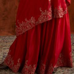 Pre Wedding Vibes - Red one shoulder silk cape with delicate embroidery teamed with matching embroidered sharara pants Composition: Kurta and Sharara- Dupion Silk Care: Dry Clean Only and Vacuum Storage This product can be customised for sleeves, length of blouse and neckline Delivery : 4-6 weeks as the product is hand crafted. For more information and sizes please contact fabiliciousfashion@gmail.com or visit our Copenhagen studio.About the Designer : Pink City by Sarika, established in 2014, i