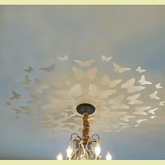 a chandelier hanging from the ceiling with butterflies on it