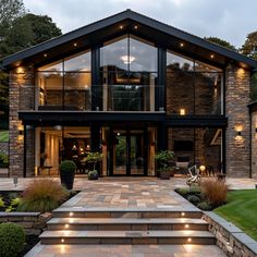 a large house with stone steps leading to it's front door and patio area