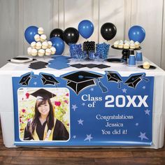 a graduation party table with balloons and decorations