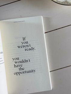 an open book sitting on top of a white table