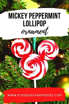 mickey peppermint lollipop ornament on top of a christmas tree