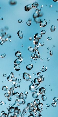 water bubbles floating in the air on a blue background