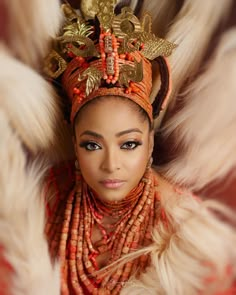 a woman wearing an elaborate headdress and jewelry